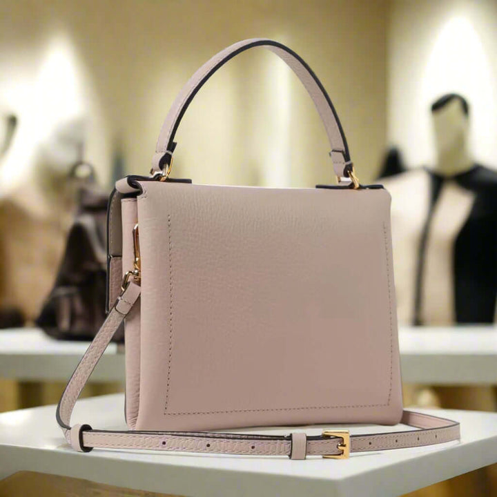 Beige handbag with a strap on a white background