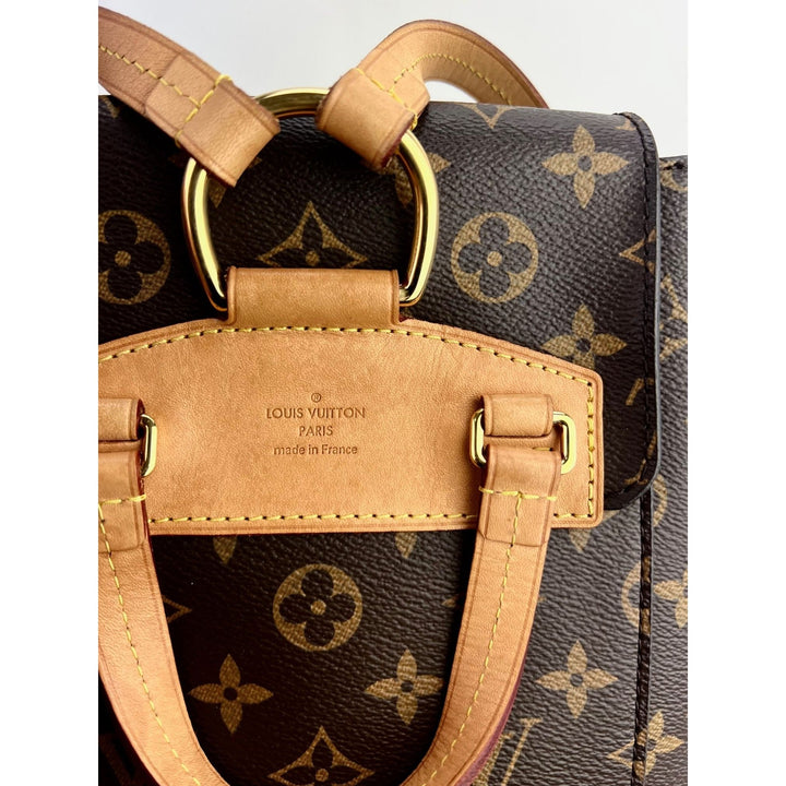 Close-up of LOUIS VUITTON Montsouris NM Monogram Backpack showing leather strap and logo detail on luxury bags.