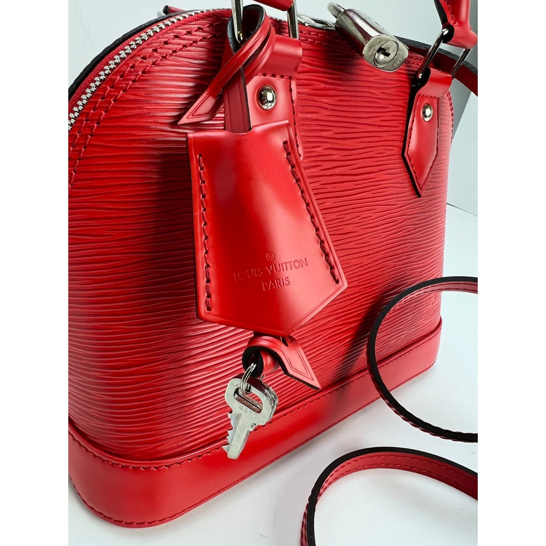 Red handbag with visible brand logo on a white background