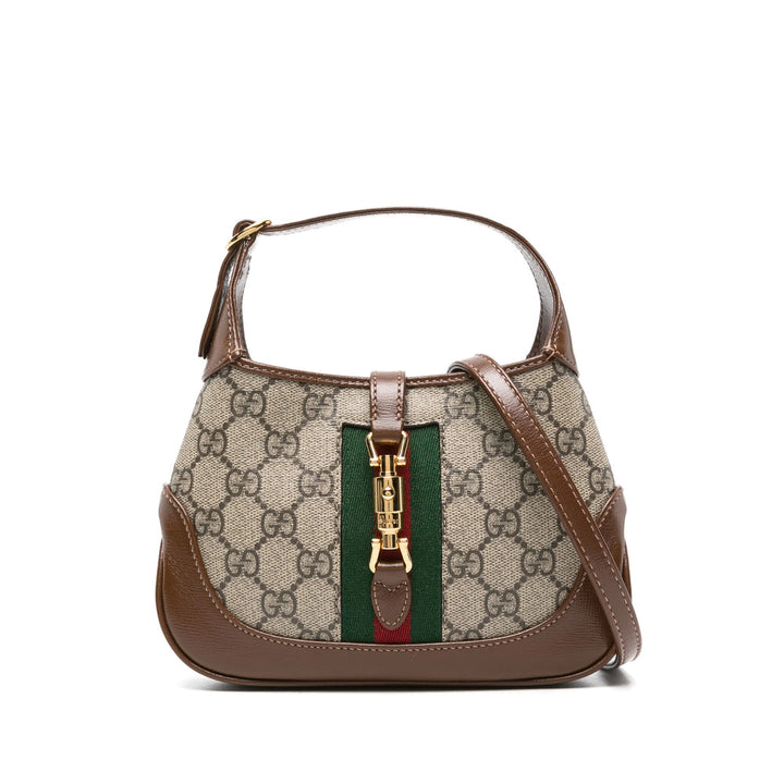 Designer handbag with brown leather accents and a visible brand logo on a white background
