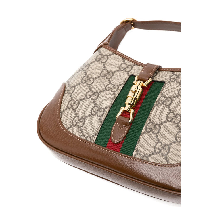 Designer handbag with recognizable brand pattern and color accents on a white background