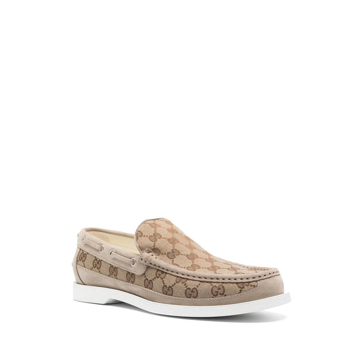 Beige loafer with Gucci logo on a white background