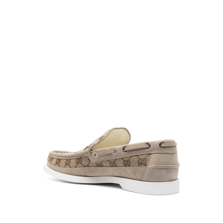 Beige boat shoe with brand logo on a white background