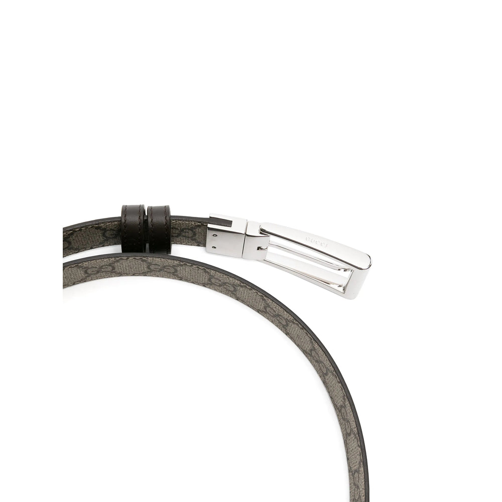 Gray leather cord with a silver clasp on a white background