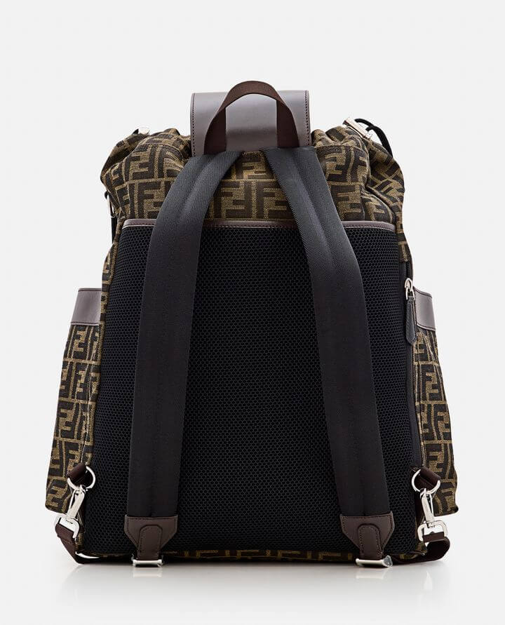Backpack with a patterned top section and black straps on a white background