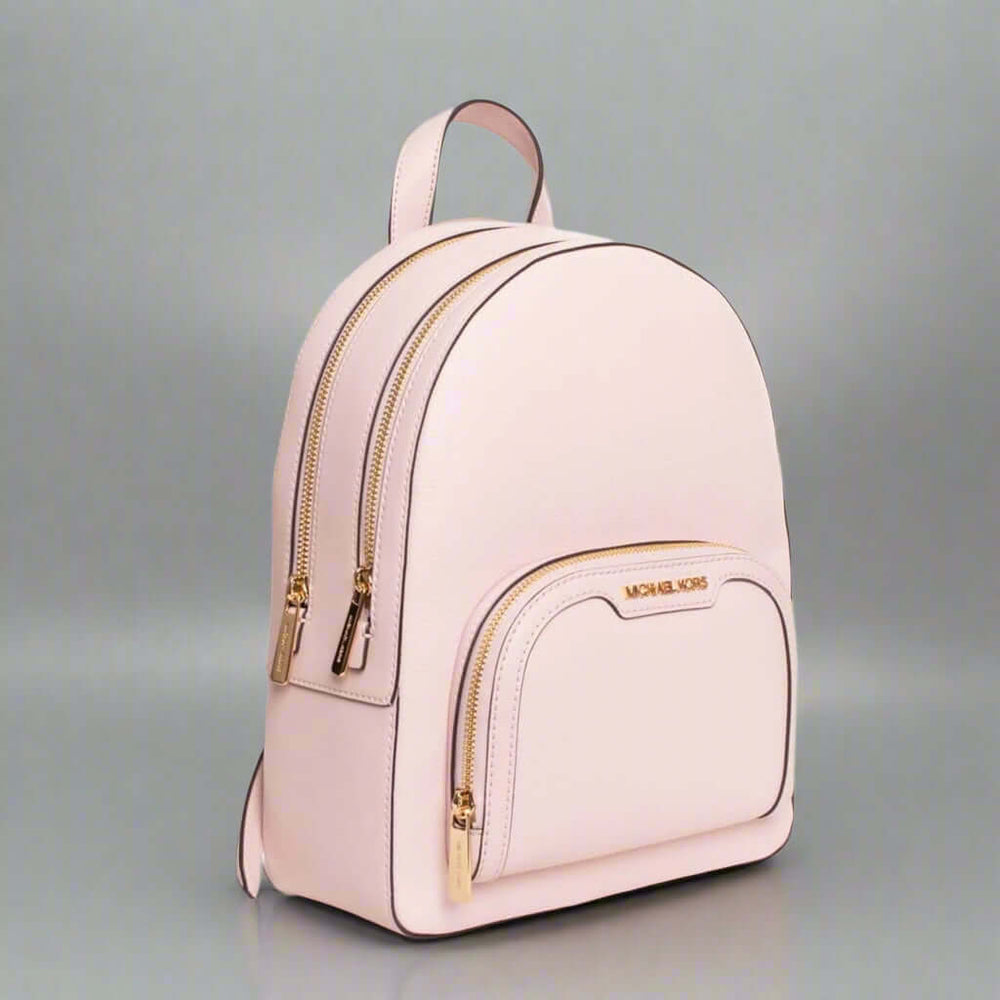 Pink backpack with gold accents on a white background