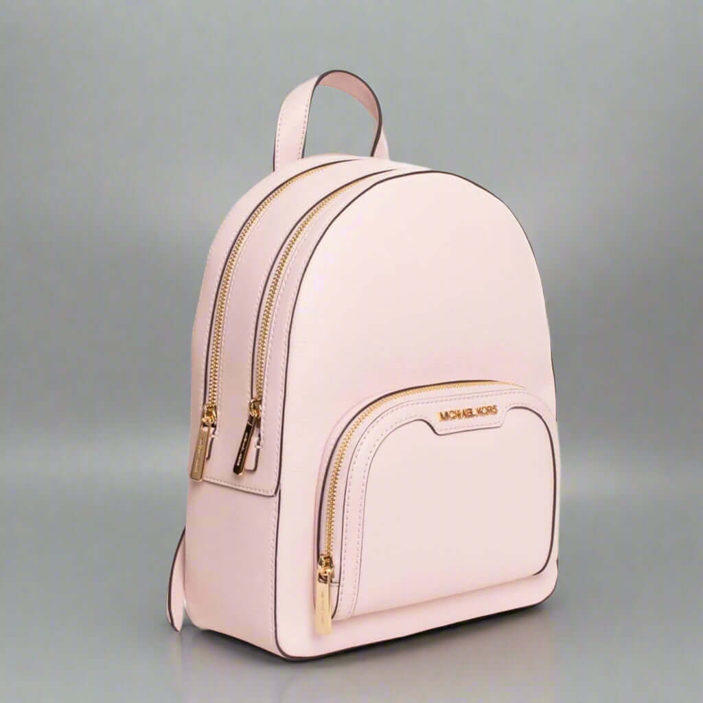 Pink backpack with gold accents on a white background