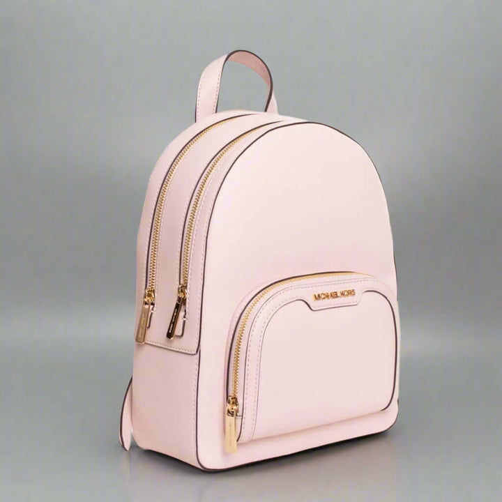 Pink backpack with gold accents on a white background
