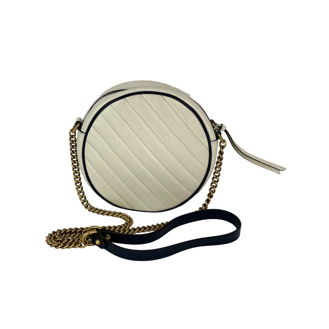 Round handbag with chain strap on a white background