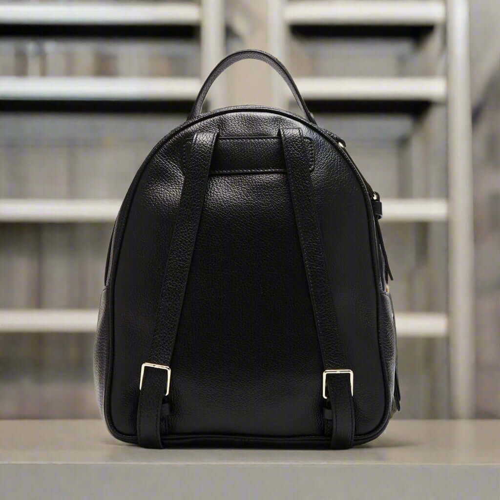 Black leather backpack on a white background