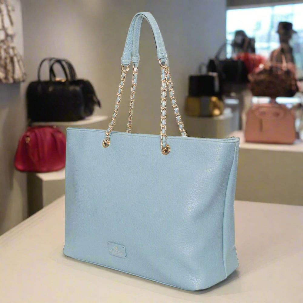 Light blue handbag with chain details on a white background
