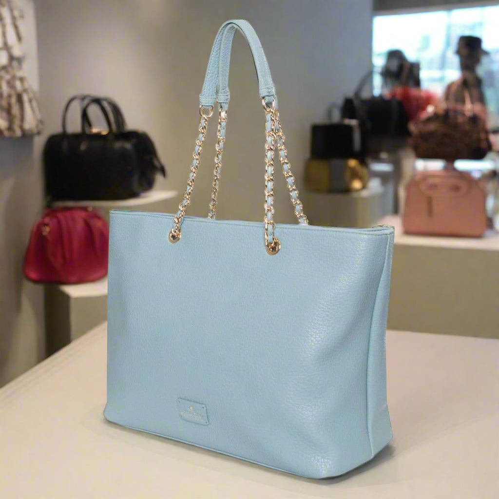 Light blue handbag with chain details on a white background
