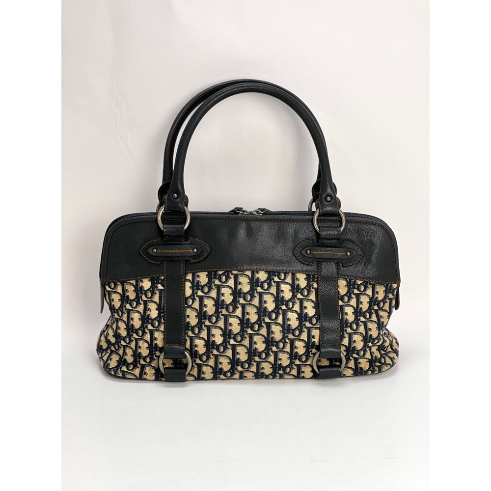 CHRISTIAN DIOR Monogram Trotter CD Blue Canvas Hand Bag shown from side, luxury bags with black leather accents and violin print.