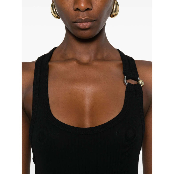 Black tank top with thin straps worn by a person on a white background