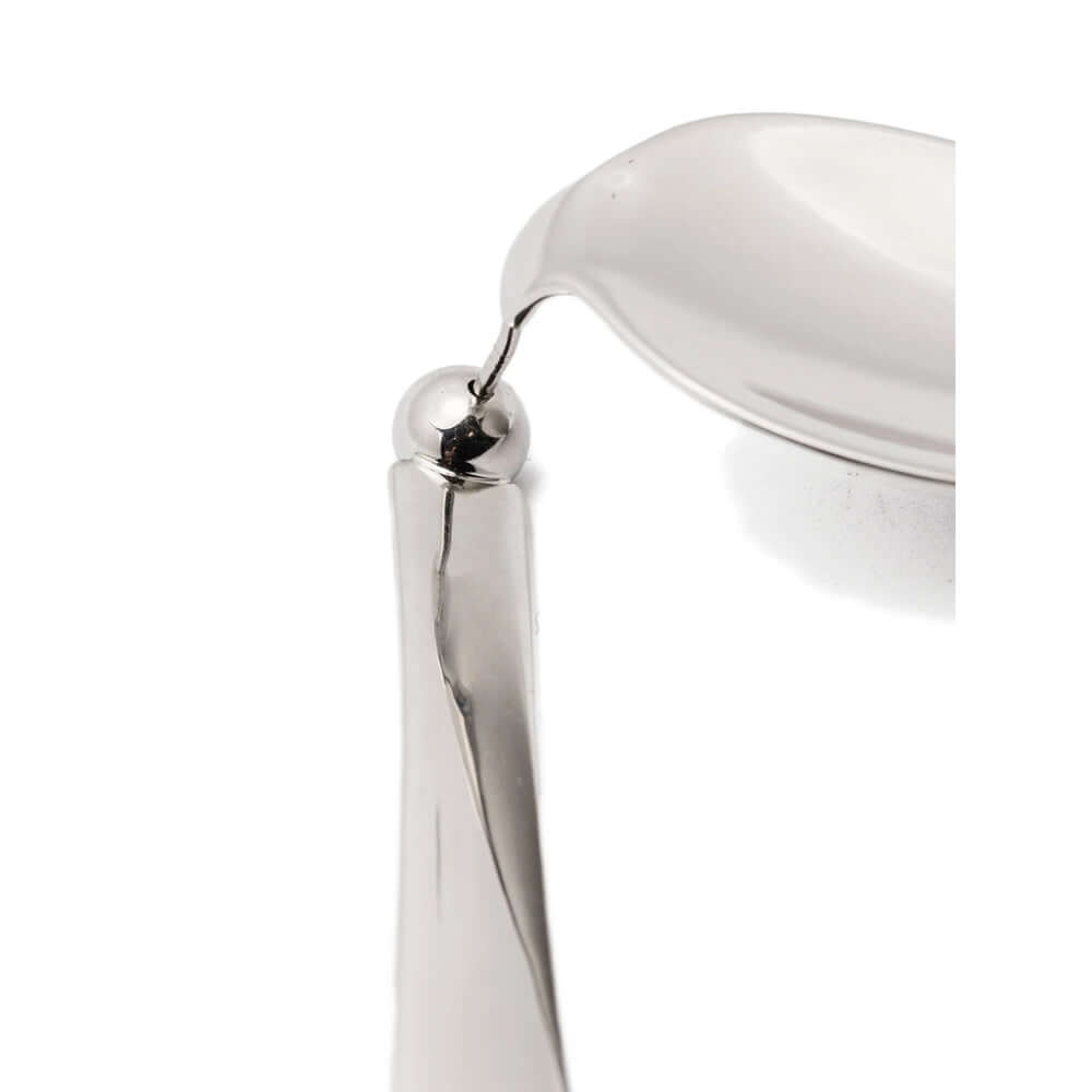 Close-up of a silver chair armrest on a white background