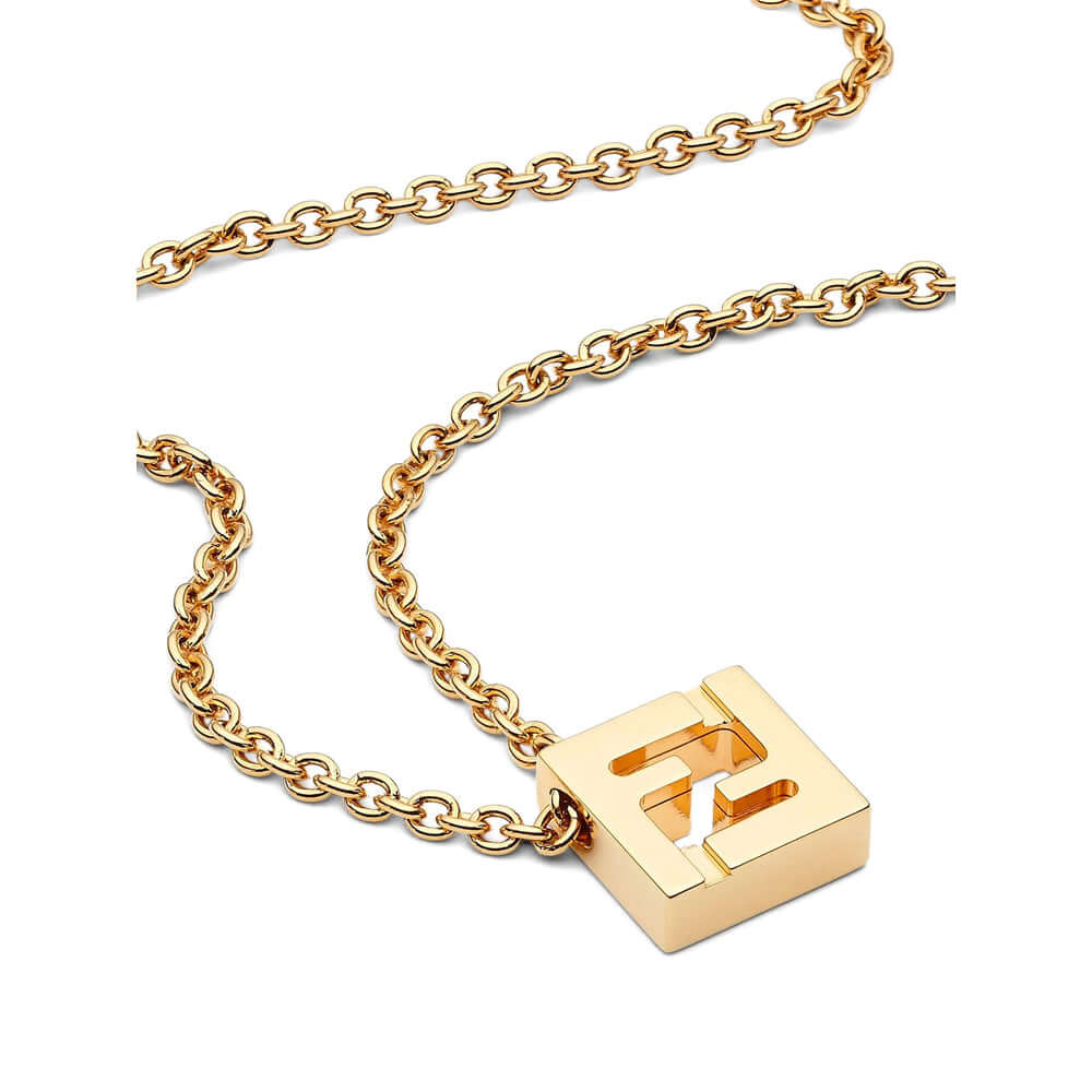 Gold necklace with a square pendant featuring a letter 'E' on a white background