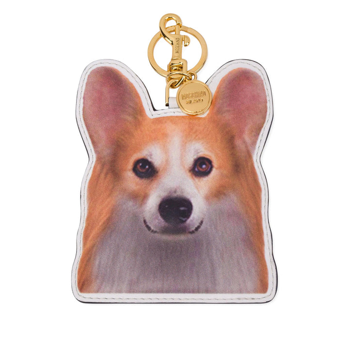 Keychain shaped like a dog's face with a gold tag on a white background