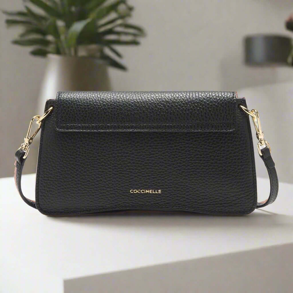 Black handbag with gold accents on a white background