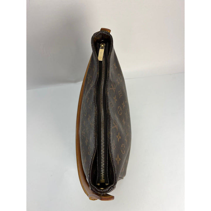 Side view of LOUIS VUITTON Looping GM Monogram Shoulder Bag showcasing the golden zipper and signature monogram pattern.