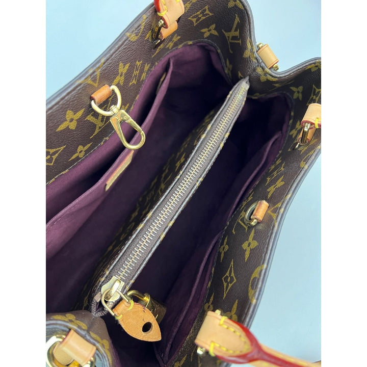 Louis Vuitton handbag with monogram pattern and purple interior