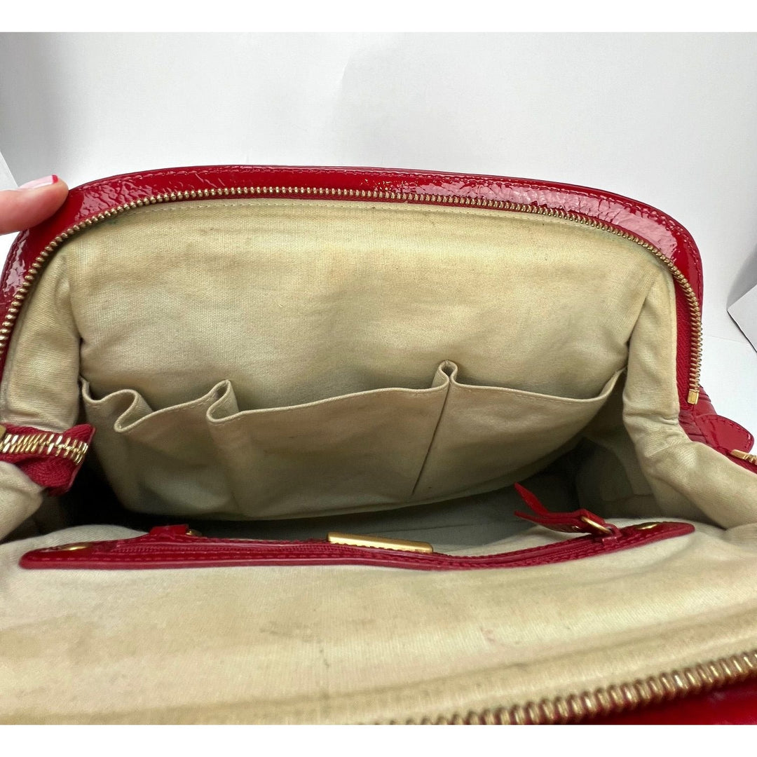 Interior view of Isabella Fiore Red Patent Leather Hand bag, showcasing beige lining and pockets, emphasizing luxury bags.