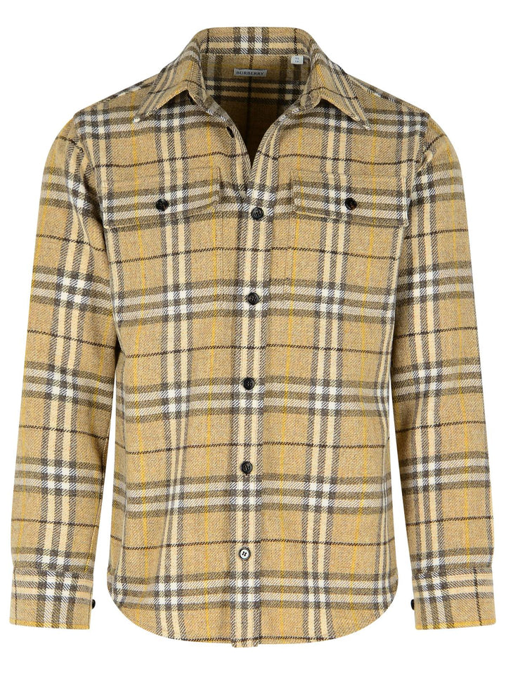 Yellow plaid shirt with black buttons on a white background