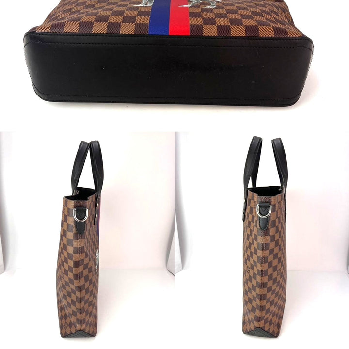 Checkered patterned bag with black base and red and blue stripe, displayed on a white background.