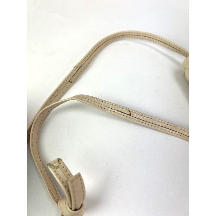 Details of the leather strap for Bottega Veneta Intreciato white leather Shoulder Clutch Bag, showcasing wear and condition.