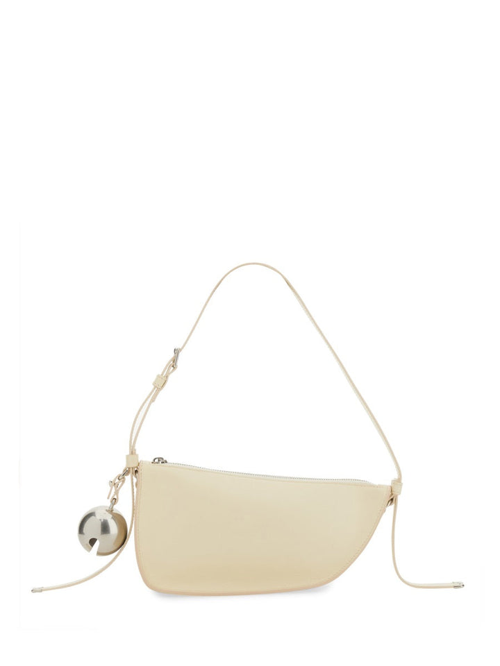 Beige handbag with a small silver ball detail on a white background