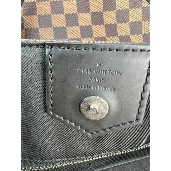 Louis Vuitton bag with checkered pattern and brand logo on a white background