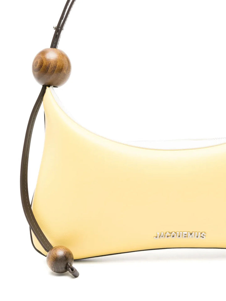 Yellow handbag with wooden beads on a white background