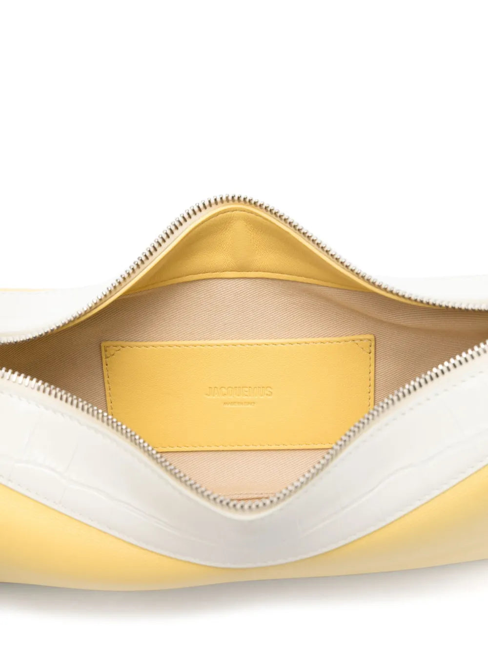 Close-up of a yellow and white leather bag with a visible brand label.