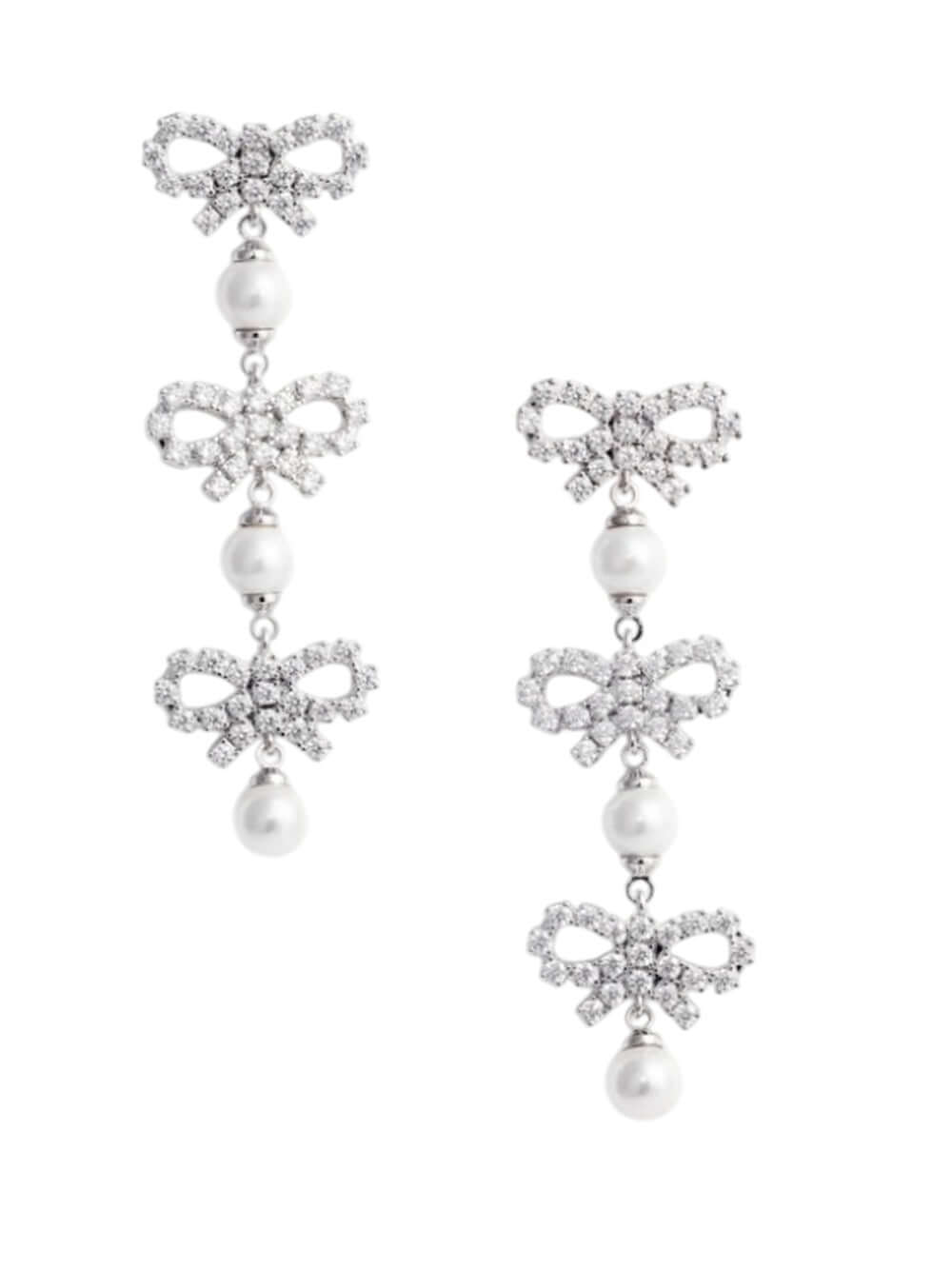 Pair of earrings with bow and pearl designs on a white background