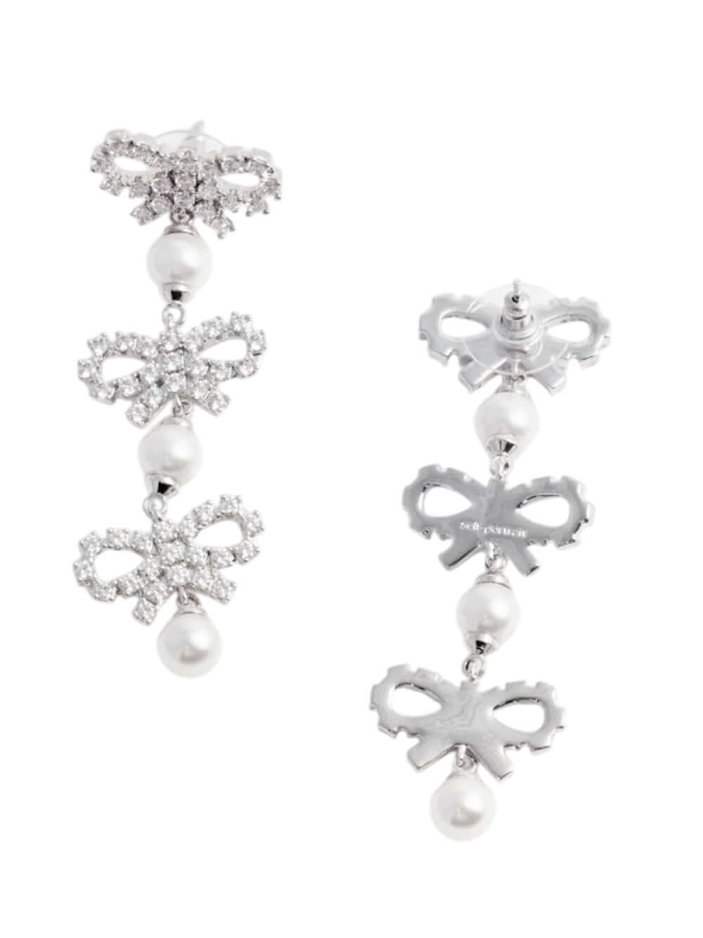 Pair of earrings with bow and pearl designs on a white background