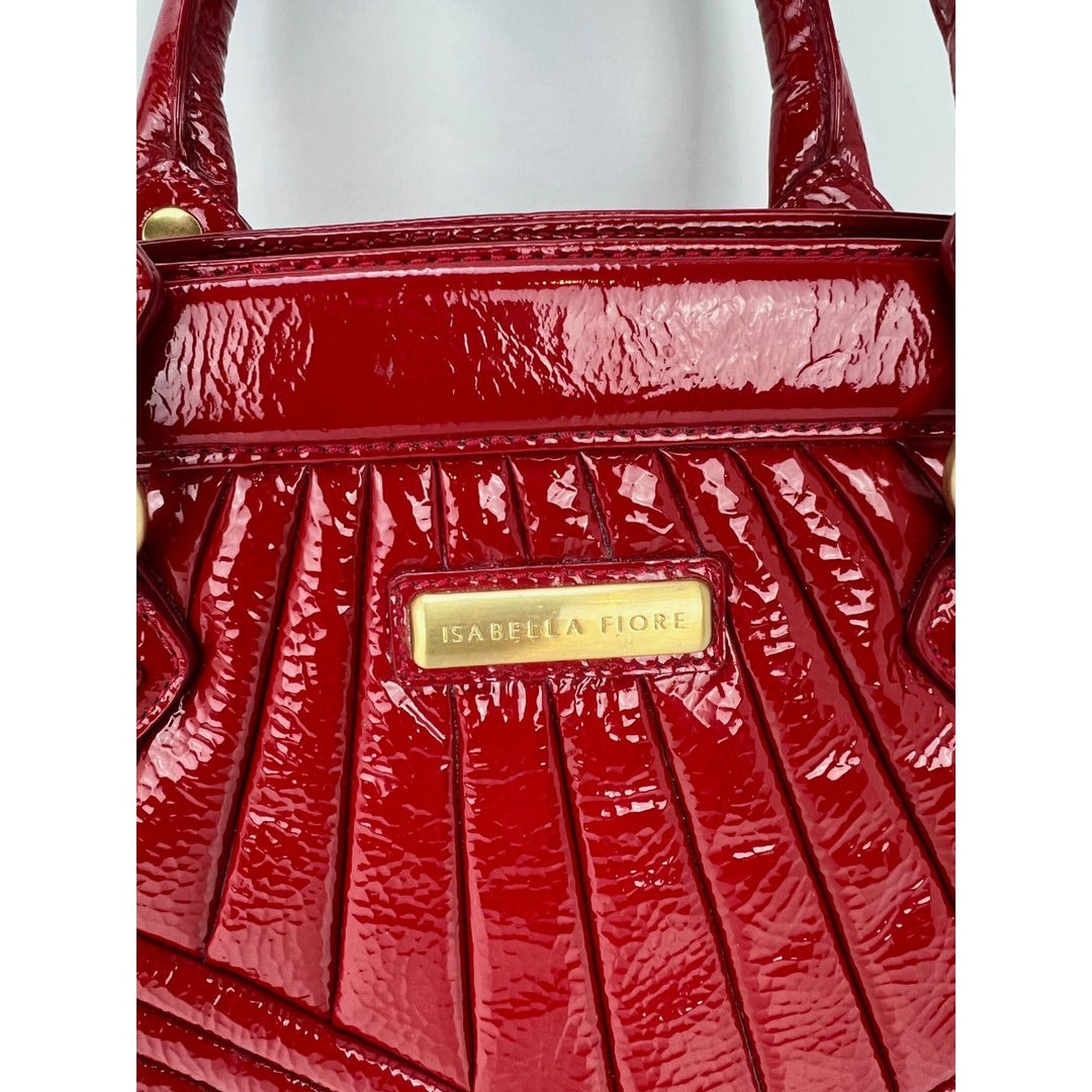 Isabella Fiore Red Patent Leather Hand bag detailed view, showcasing luxurious patent leather and designer hardware.