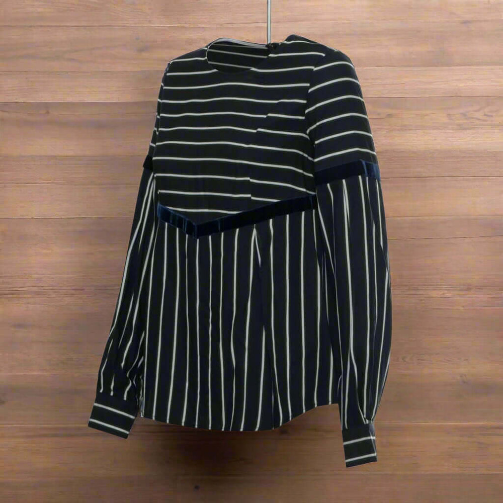 Black and white striped shirt with velvet accents on a white background