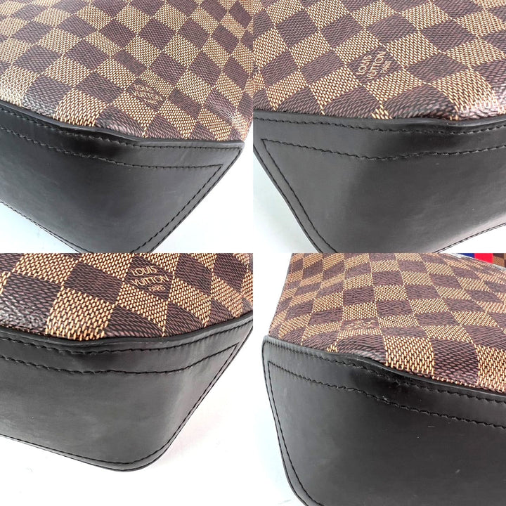 Close-up of a Louis Vuitton bag with checkered pattern and visible logo.