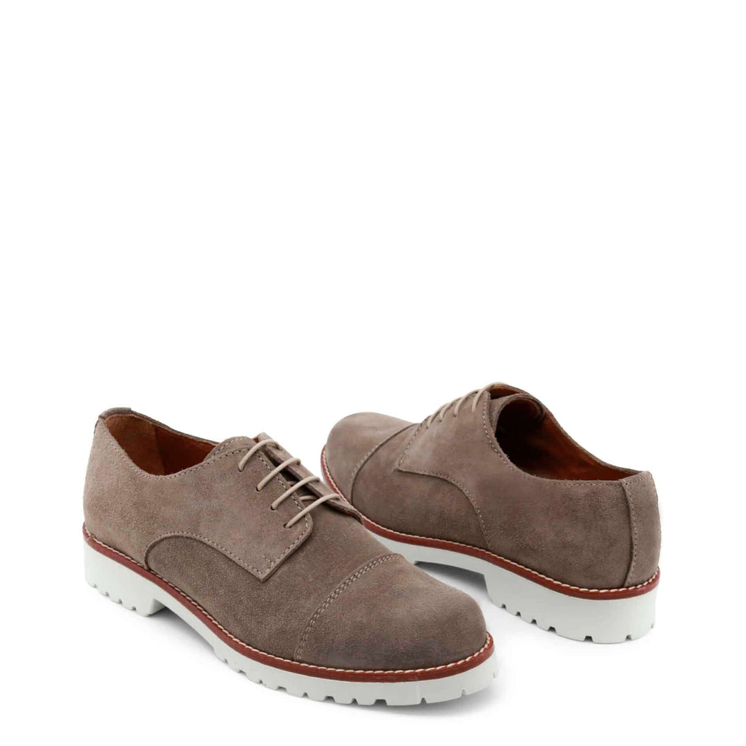 Pair of brown suede shoes with white soles on a white background