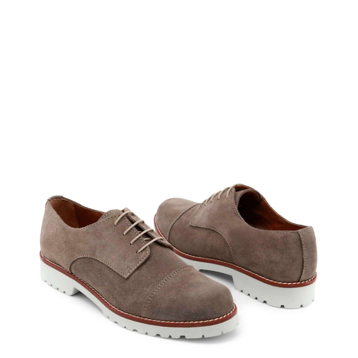 Pair of brown suede shoes with white soles on a white background