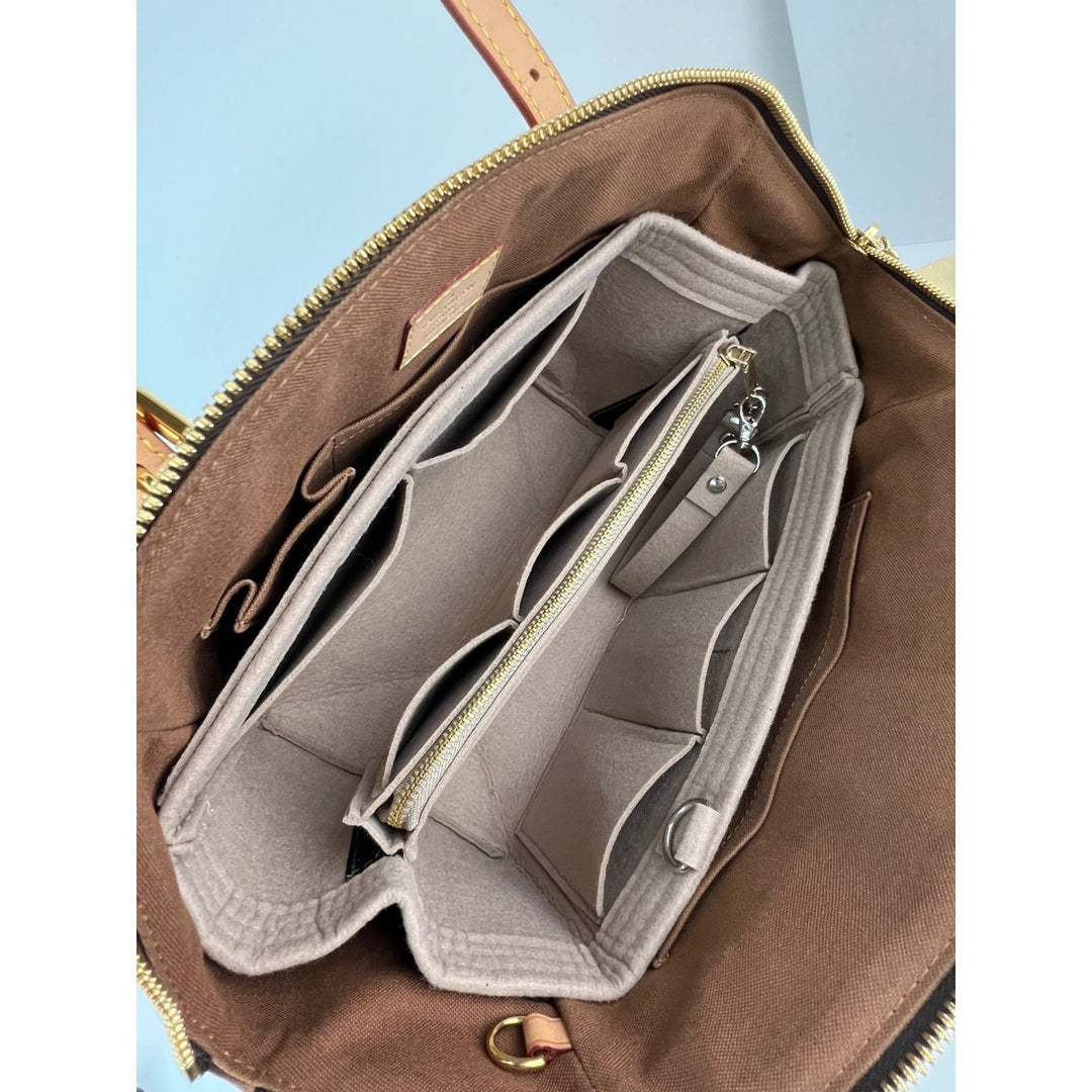 Brown leather bag with open compartment showing beige interior