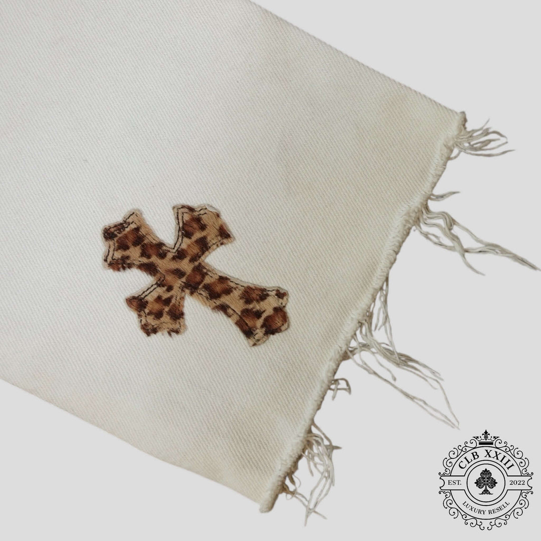 Chrome Hearts Leopard Cross Patch Jeans in White featuring a leopard print cross patch on a white fabric.