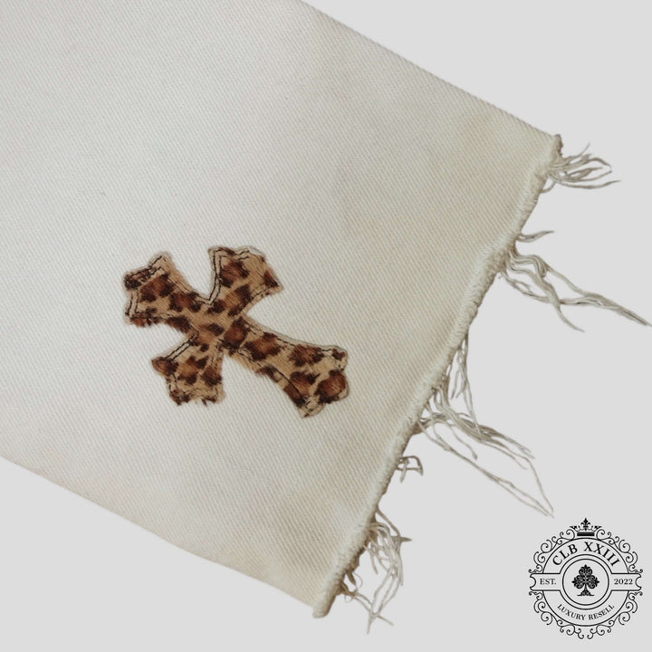Chrome Hearts Leopard Cross Patch Jeans in White featuring a leopard print cross patch on a white fabric.