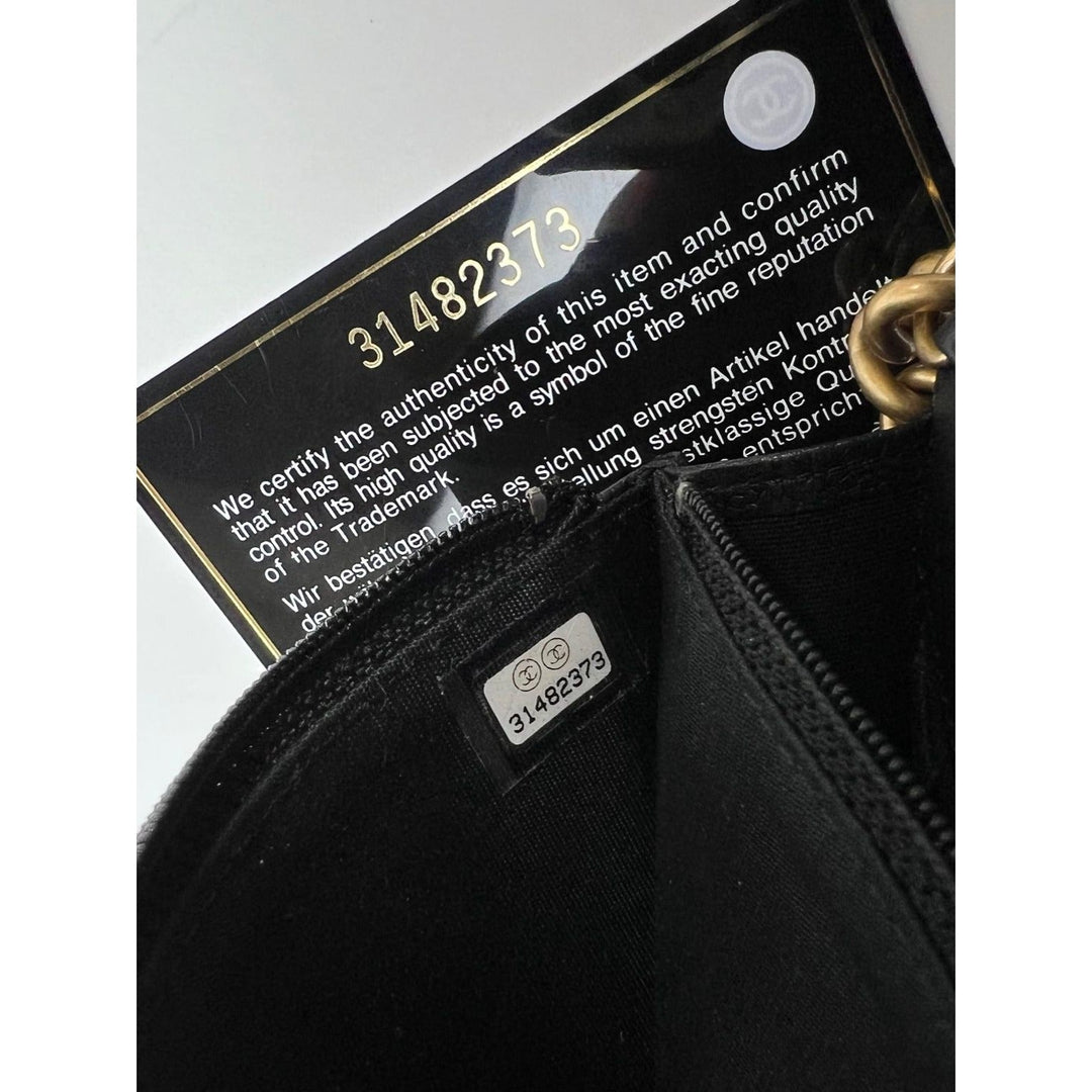 Chanel Caviar Quilted Mini Boy Clutch Wallet on a Chain Black authenticity card and interior details