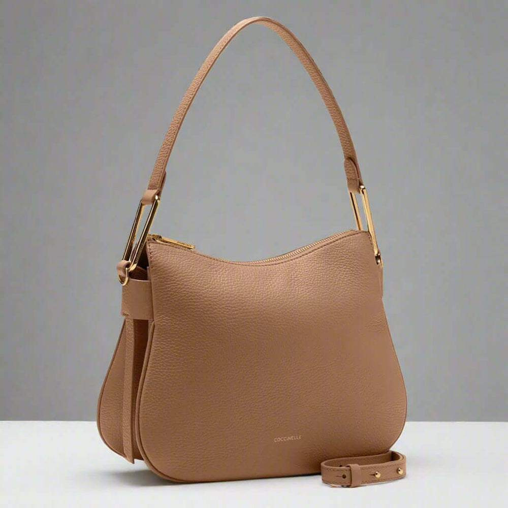 Brown handbag with gold hardware on a white background