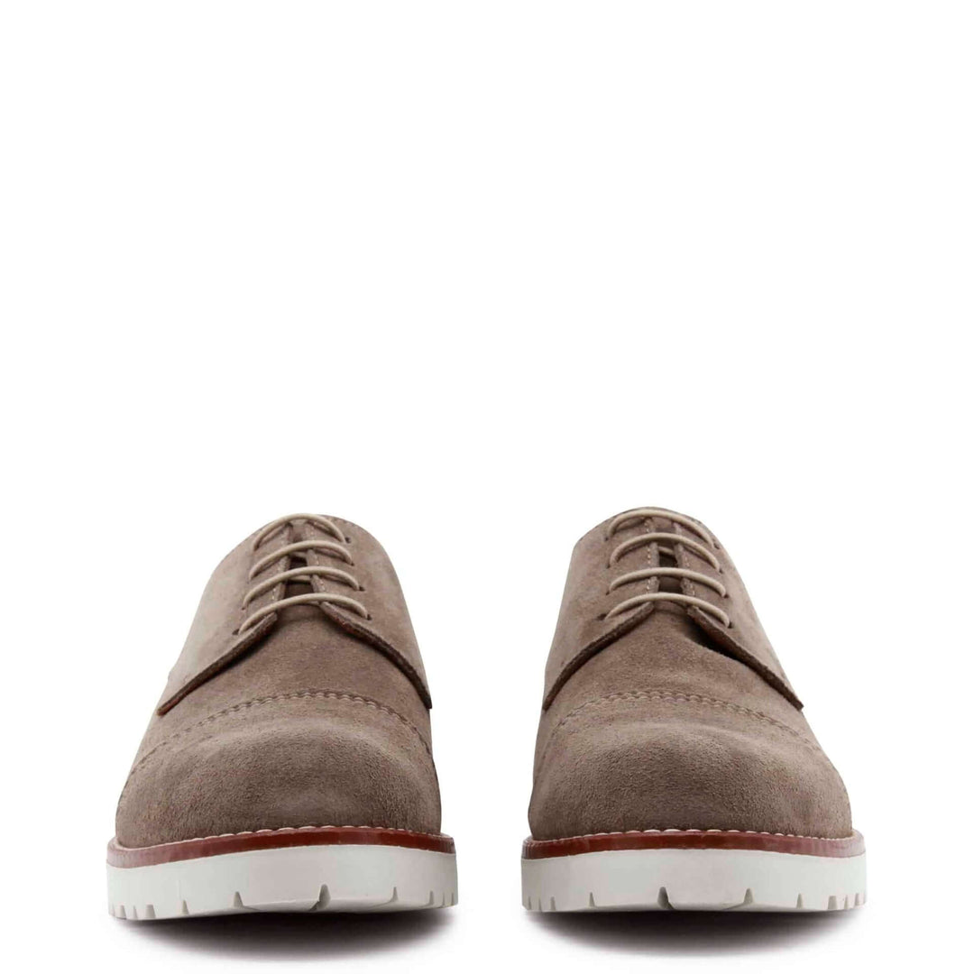 Pair of brown suede shoes on a white background