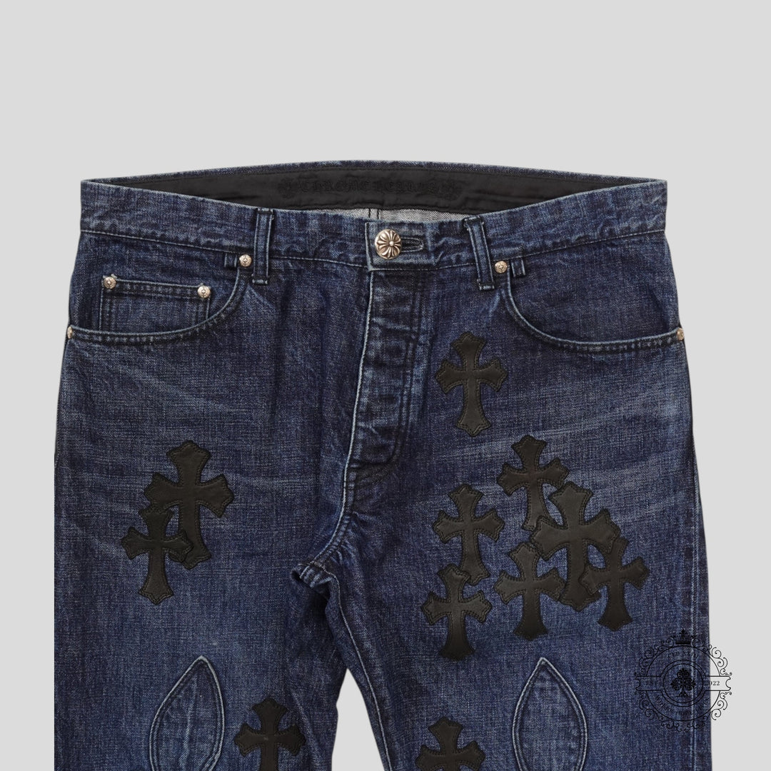 Blue jeans with black cross patterns on a light gray background