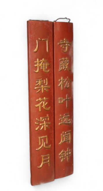 Two red leather-bound books with gold text on a white background