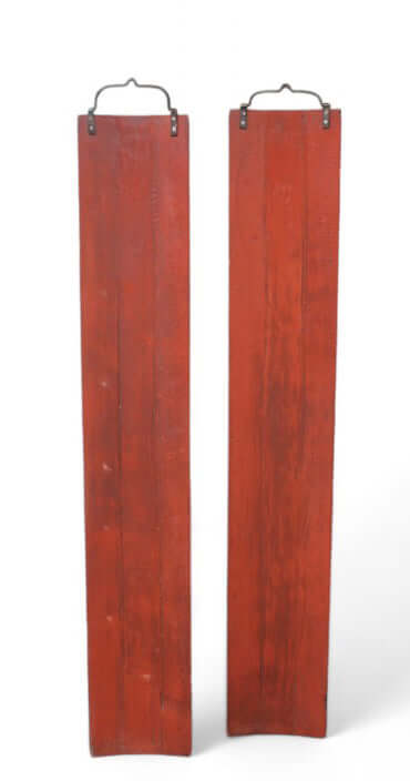 Two vertical red panels with metal brackets on a white background