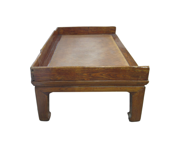 Wooden table with a brown leather top on a white background