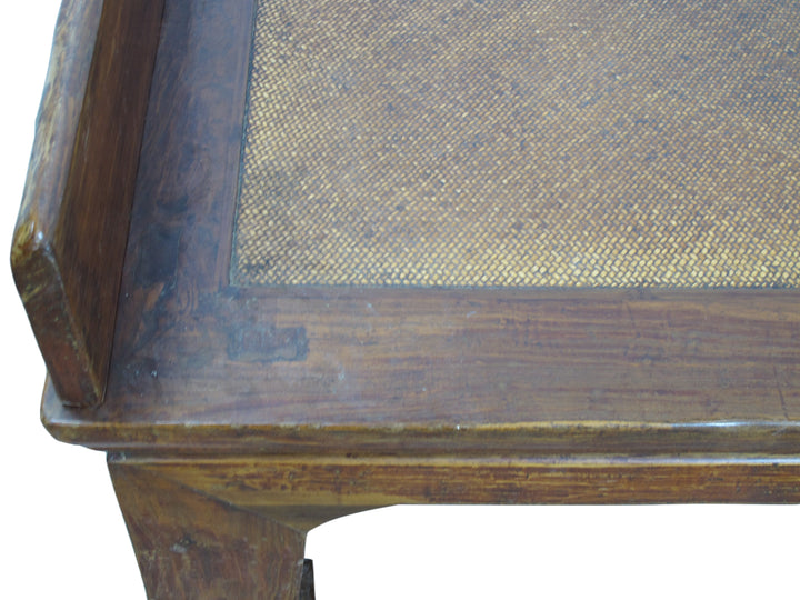 Wooden table with woven surface on a white background